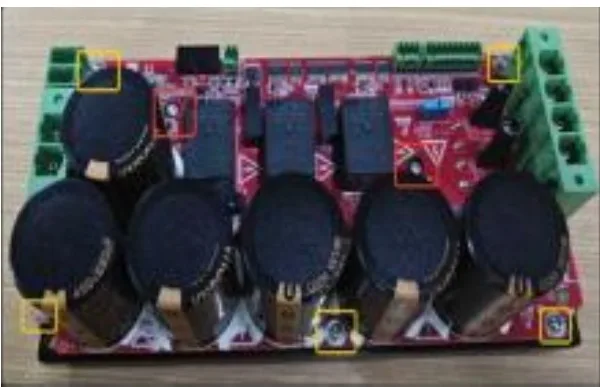 Industrial robot power-stage board with large capacitors and terminal blocks